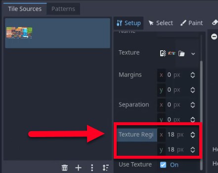 Aquesta imatge mostra la interfície de l'editor TileSet de Godot, concretament la pestanya "Configuració" on s'ajusten les dimensions de les rajoles: una fletxa vermella apunta als camps "Mida de la regió de textura", que s'estableixen en x = 18 px i y = 18 px, corregint la mida predeterminada de 16 x 16 píxels perquè coincideixi amb les dimensions reals de la textura tal com s'indica a la lliçó. El tauler "Fonts de rajoles" de l'esquerra mostra l'atles de rajoles importat ("tiles_packed.png"), confirmant que la textura està carregada i preparada per utilitzar-la. Aquest pas garanteix que les fitxes s'alineen correctament quan es pinten a TileMapLayer.
