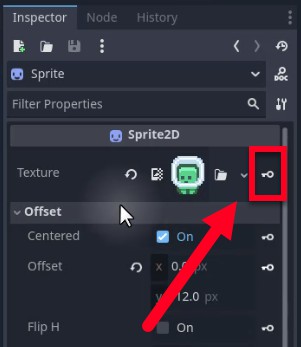 Al tauler Godot Inspector, la propietat Textura del node Sprite2D està seleccionada, amb una fletxa vermella que apunta al botó del fotograma clau (una petita icona de diamant) al costat, que indica el pas per crear una pista d'animació per a la propietat de textura com a part de la configuració de l'animació inactiva; la secció Offset a continuació mostra X establert a 0,0 px i Y configurat a 12,0 px, amb Centrat activat, que són paràmetres de posicionament de sprites no relacionats amb la configuració de l'animació actual però visibles en context.