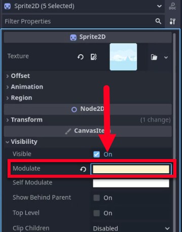 Al panell Inspector de l'editor Godot, les propietats del node Sprite2D es mostren amb cinc instàncies seleccionades; una fletxa vermella assenyala el camp de propietat "Modular", que està ressaltat en un quadre vermell i actualment buit, indicant que està preparat per introduir-se. Aquest pas probablement segueix la modificació del fons o dels sprites per al nivell 2, on l'ajust del color del modular pot matisar o alterar l'aspecte dels sprites per millorar el tema del desert.